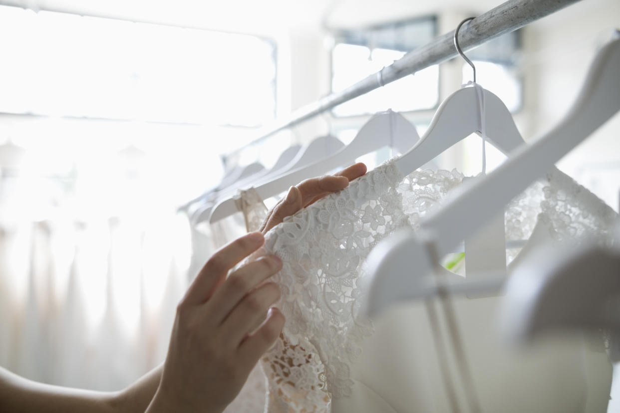 Bride shopping for wedding dresses in bridal boutique