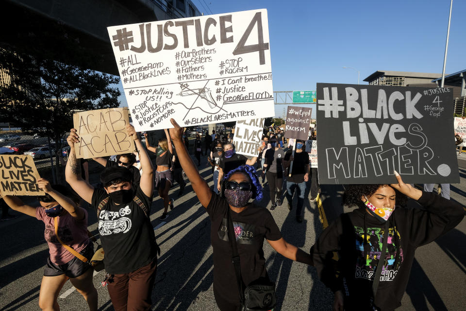 Demonstrators shut down the Hollywood Freeway in Los Angeles on Wednesday, May 27, 2020, during a protest about the death of George Floyd in police custody in Minneapolis earlier in the week. (AP Photo/Ringo H.W. Chiu)