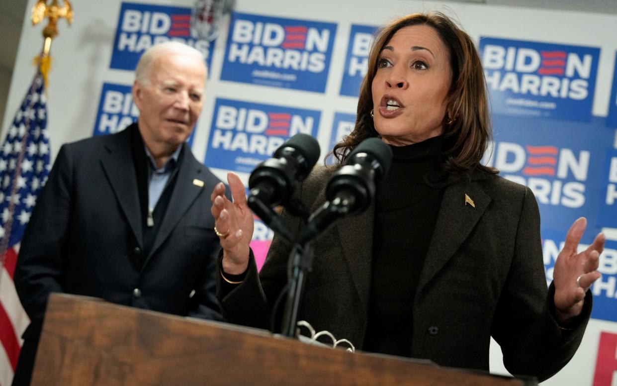 Vice President Kamala Harris speaks next to U.S. President Joe Biden