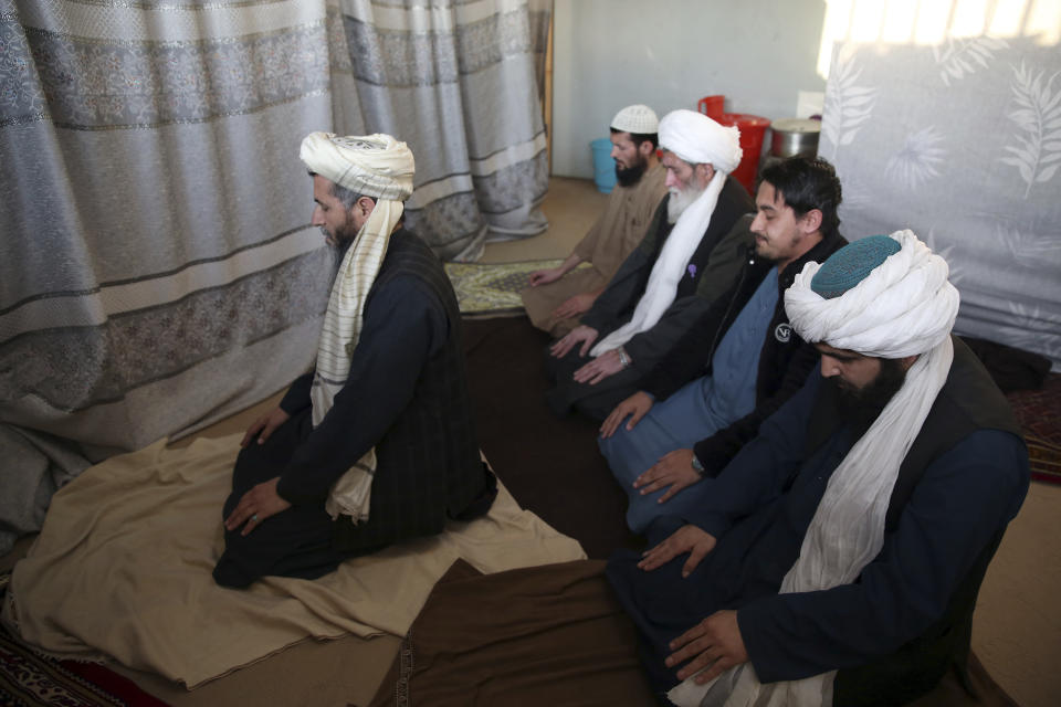 In this Saturday, Dec. 14, 2019, photo, Jailed Taliban pray inside the Pul-e-Charkhi jail after an interview with The Associated Press in Kabul, Afghanistan. Thousands of Taliban prisoners jailed as insurgents see a peace deal being hammered out in Qatar as their ticket to freedom. Prisoner release is a key pillar of any agreement the U.S. strikes with the Taliban to end Afghanistan’s 18-year war. (AP Photo/Rahmat Gul)