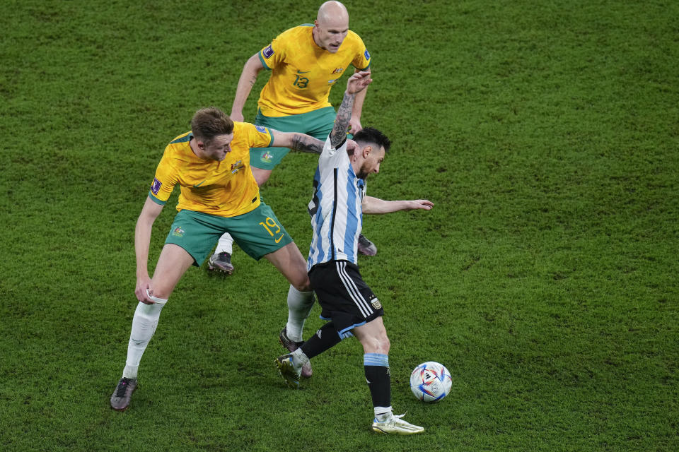 Argentina's Lionel Messi, right, tussles for the ball with Australia's Harry Souttar during the World Cup round of 16 soccer match between Argentina and Australia at the Ahmad Bin Ali Stadium in Doha, Qatar, Saturday, Dec. 3, 2022. (AP Photo/Manu Fernandez)