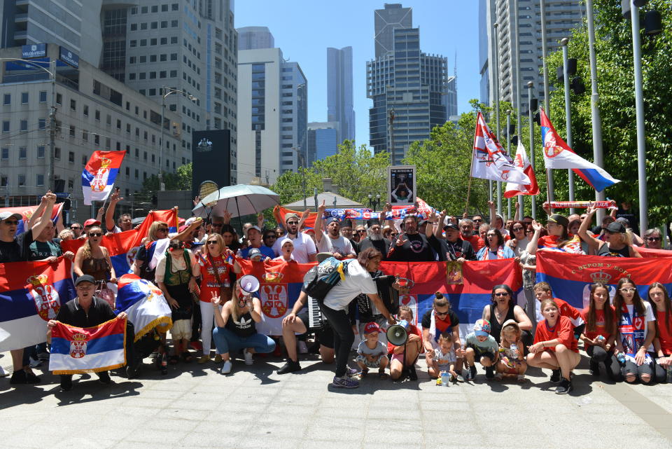 MELBOURNE, AUSTRALIA - JANUARY 10: People celebrate after Australian court quashes visa cancellation for Novak Djokovic on January 10, 2022 in Melbourne, Australia. Djokovic is in a detention hotel in Melbourne after his visa was cancelled on arrival to Australia last week. (Photo by Recep Sakar/Anadolu Agency via Getty Images)