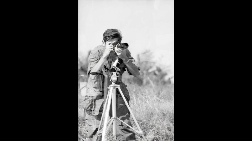 Robert J. Ellison (pictured) shooting in the field in Vietnam, where he covered the war as a civilian photographer for Newsweek and Times magazines. An exhibit of Ellison’s work opens Monday, Aug. 14, at the Hatheway Gallery on the Lewis & Clark Community College Godfrey campus. Photo courtesy of the Wisconsin Veterans Museum