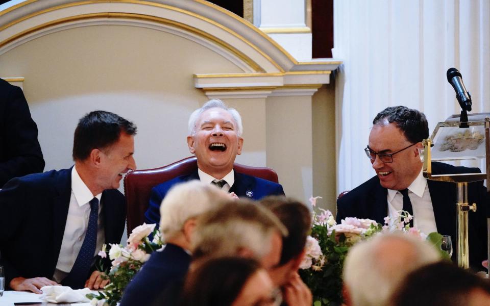 Chancellor Jeremy Hunt, the Lord Mayor of the City of London Nicholas Lyons and Governor of the Bank of England Andrew Bailey share a joke