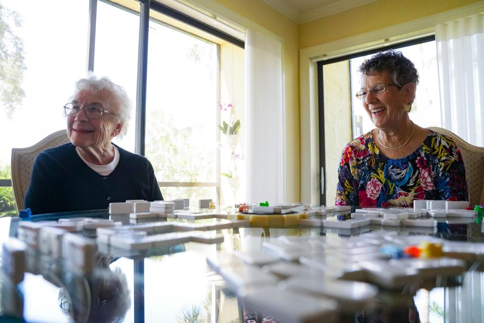 Lydia Kruesi, 100, laughs with her daughter Cindy, 76, while playing dominos at Vi at Bentley Village retirement community in Naples on Monday, May 1, 2023.