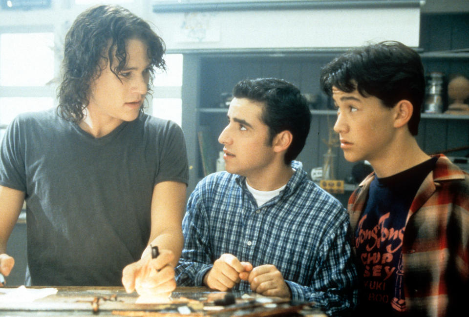 Heath Ledger, David Krumholtz, and Joseph Gordon-Levitt standing at table in a scene from the film '10 Things I Hate About You', 1999. (Photo by Buena Vista/Getty Images