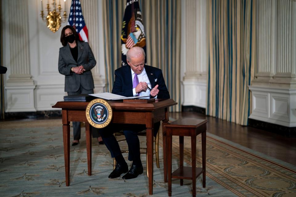 Vice President Kamala Harris looks on as President Joe Biden signs executive orders related to his racial equity agenda on Jan. 26, 2021.