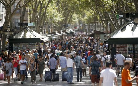 A man takes a selfie at Las Ramblas in Barcelona, Spain, August 16, 2015. REUTERS/Albert Gea