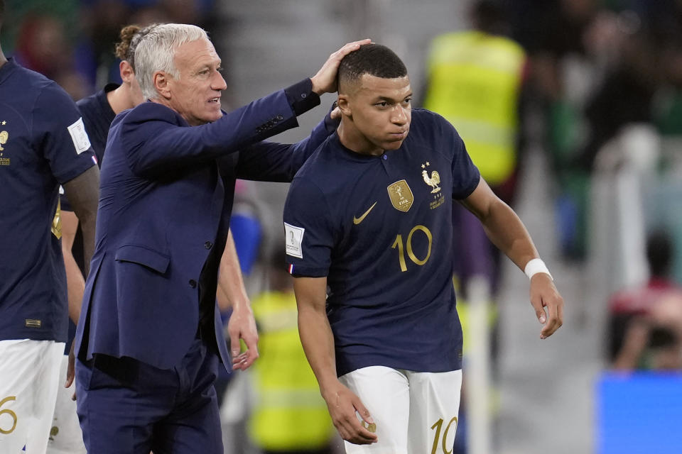 France's head coach Didier Deschamps, left, celebrates a goal by France's Kylian Mbappe, right, during the World Cup round of 16 soccer match between France and Poland, at the Al Thumama Stadium in Doha, Qatar, Sunday, Dec. 4, 2022. (AP Photo/Natacha Pisarenko)