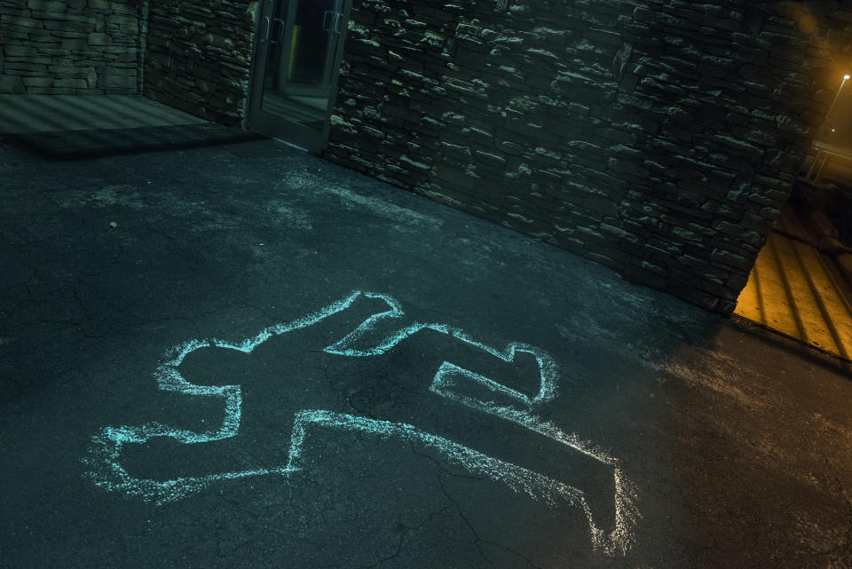 Chalk outline of body of victim on pavement