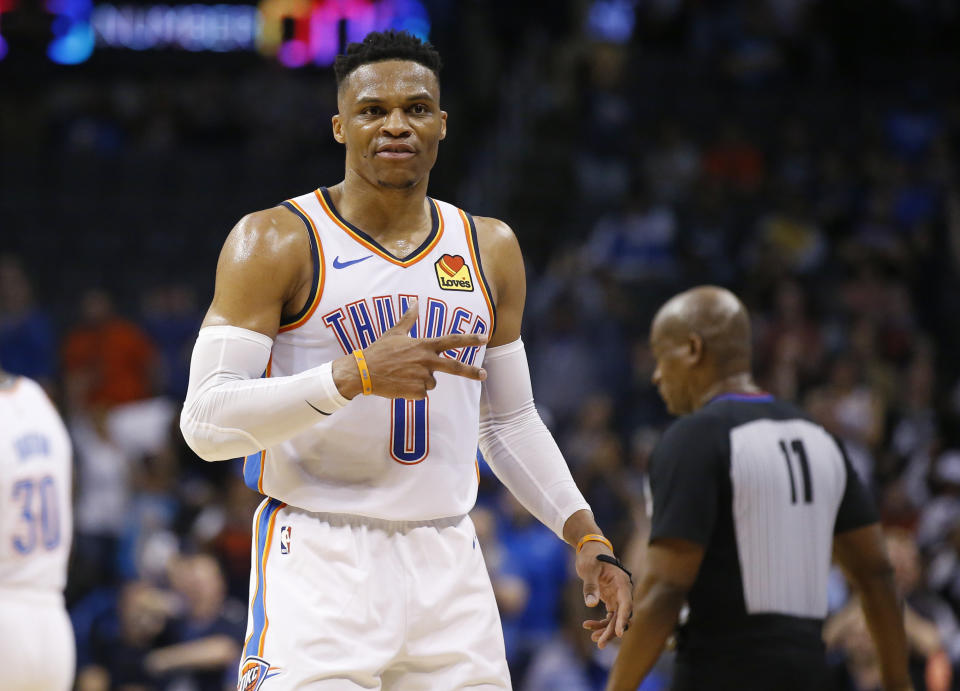 Oklahoma City Thunder guard Russell Westbrook (0) gestures to the crowd in the second half of an NBA basketball game against the Los Angeles Lakers, Tuesday, April 2, 2019, in Oklahoma City. Westbrook became just the second player in NBA history to have 20 points, 20 rebounds and 20 assists in a game as the Oklahoma City Thunder defeated the Los Angeles Lakers 119-103. (AP Photo/Sue Ogrocki)