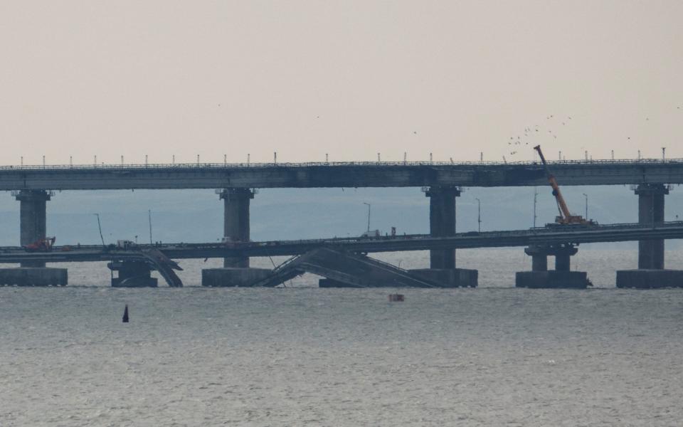 A view shows parts of the Crimea bridge, damaged in an explosion, in the Kerch Strait - REUTERS