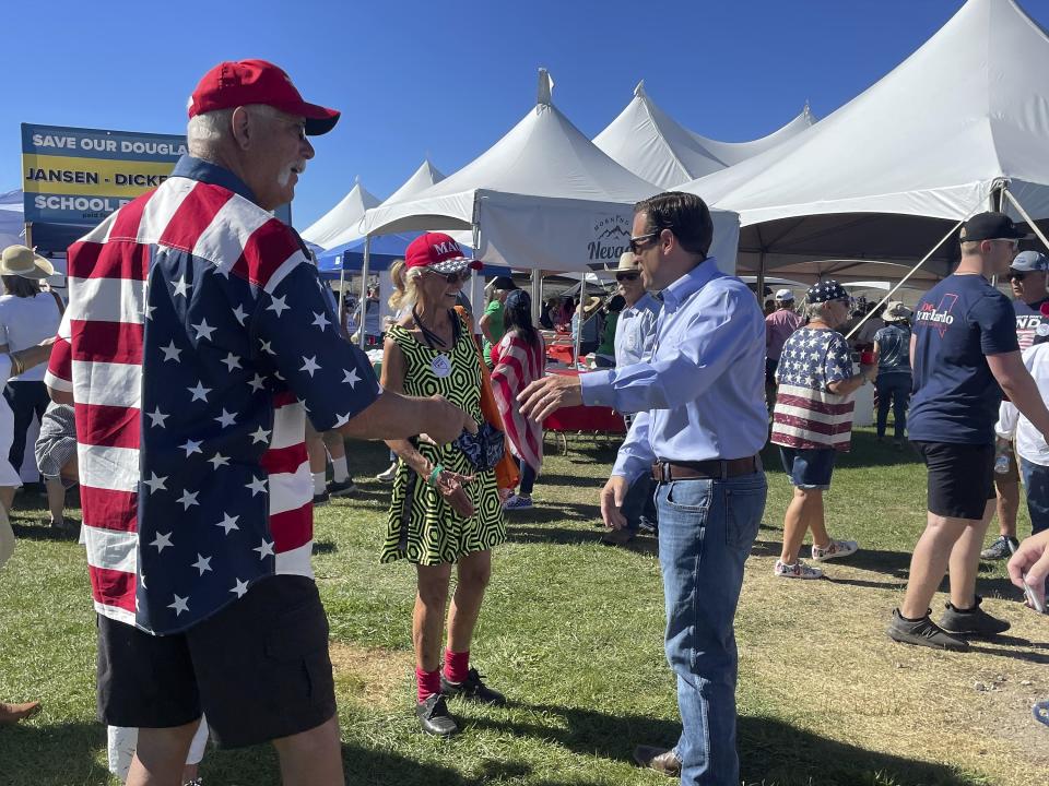 Republican Nevada Senate candidate Adam Laxalt, right, takes pictures with supporters at the seventh annual Basque Fry at the Corley Ranch on Saturday, Aug. 13, 2022, outside Gardnerville, Nevada. (Gabe Stern / AP)