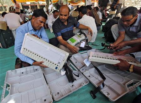 Election staff check electronic voting machines (EVM) at a distribution centre ahead of the fifth phase of India's general election at Sirohi district in the desert state of Rajasthan April 16, 2014. REUTERS/Amit Dave