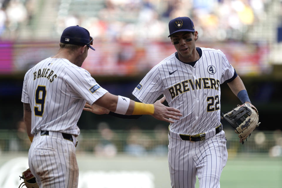 Milwaukee Brewers' Christian Yelich (22) is congratulated by Jake Bauers (9) after throwing out a runner at home during the eighth inning of a baseball game against the Chicago White Sox, Sunday, June 2, 2024, in Milwaukee. (AP Photo/Aaron Gash)