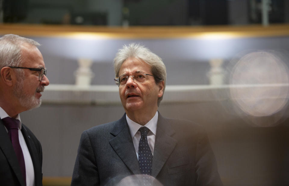 European Commissioner for Economy Paolo Gentiloni, right, speaks with President of the European Investment Bank Werner Hoyer during a meeting of EU finance ministers at the Europa building in Brussels, Tuesday, Feb. 18, 2020. EU finance ministers meet Tuesday to discuss tax havens. (AP Photo/Virginia Mayo)