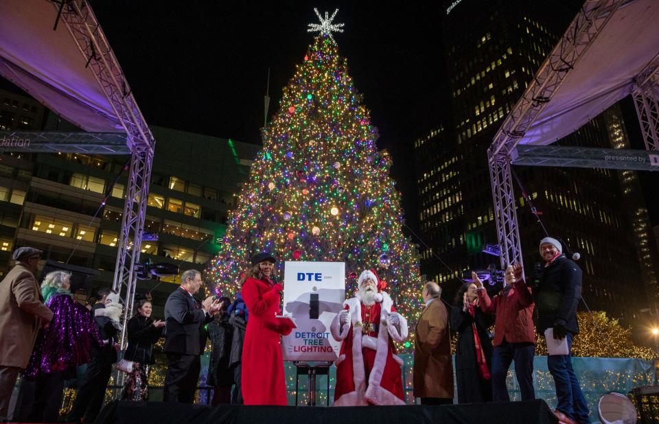 Santa Claus, Mayor Mike Duggan, Dr. Sonia Hassan and others stand on stage during the 20th Annual Tree Lighting in downtown Detroit on Friday, Nov. 17, 2023.