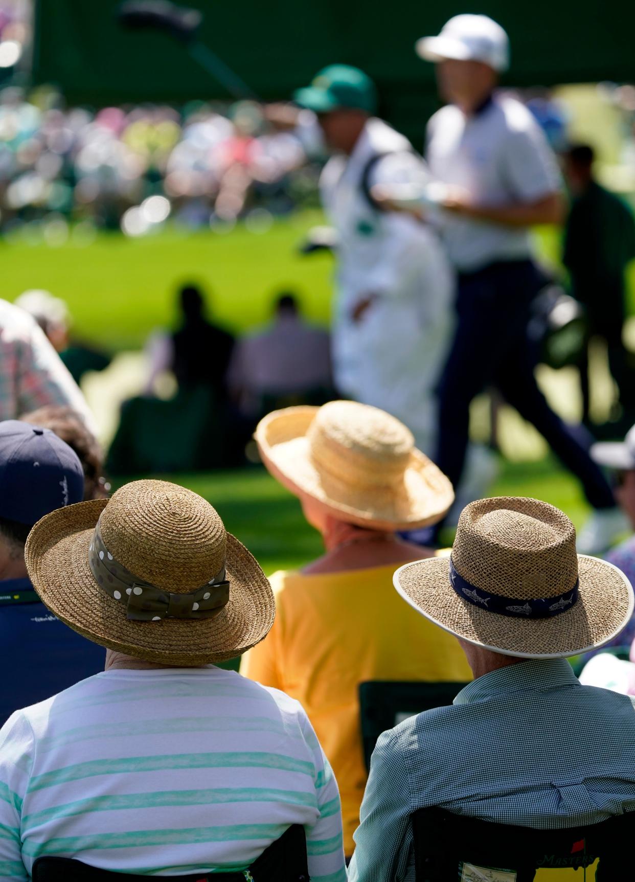 FILE - Apr 7, 2022; Augusta, Georgia, USA; Patrons in straw hats watch golfers walk off the no. 17 tee during the first round of The Masters golf tournament at Augusta National Golf Club. Mandatory Credit: Andrew Davis Tucker-Augusta Chronicle/USA TODAY Sports