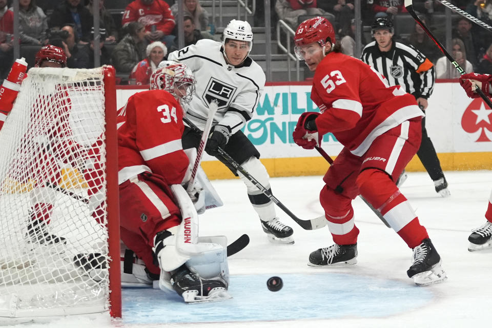 Detroit Red Wings goaltender Alex Lyon (34) deflects a Los Angeles Kings left wing Trevor Moore (12) shot in the first period of an NHL hockey game Saturday, Jan. 13, 2024, in Detroit. (AP Photo/Paul Sancya)