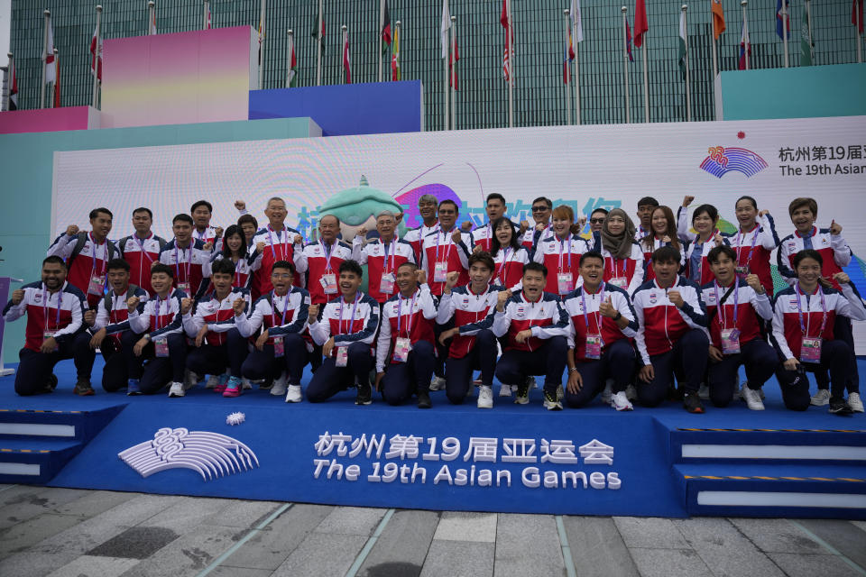 Athletes and team officials from Thailand cheer as they pose for a group photo during a team welcoming ceremony at the 19th Asian Games in Hangzhou, China, Friday, Sept. 22, 2023. (AP Photo/Aaron Favila)