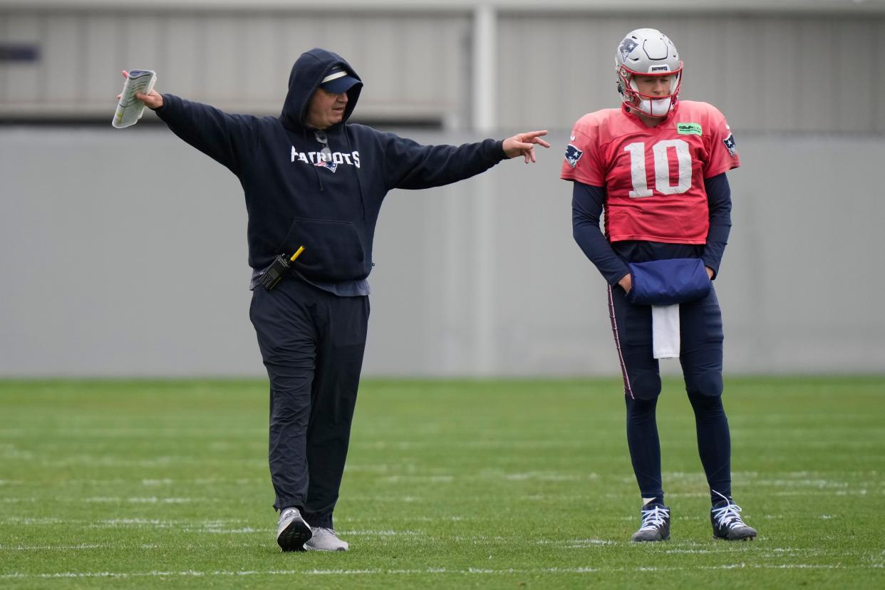 New England Patriots offensive coordinator Bill O'Brien points while standing near quarterback Mac Jones (10) during an NFL football practice, Wednesday, Nov. 1, 2023, in Foxborough, Mass. (AP Photo/Steven Senne)