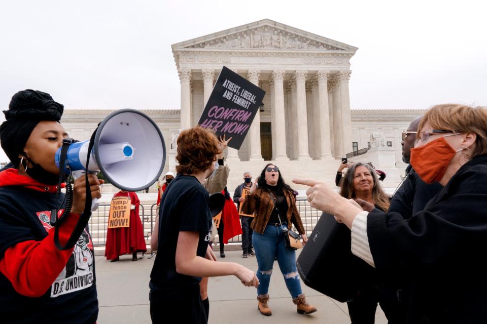 People demonstrate for and against the nomination of Amy Coney Barrett to the Supreme Court, Monday, Oct. 26, 2020, outside the Supreme Court on Capitol Hill in Washington. (AP Photo/Jacquelyn Martin) ORG XMIT: DCJM103