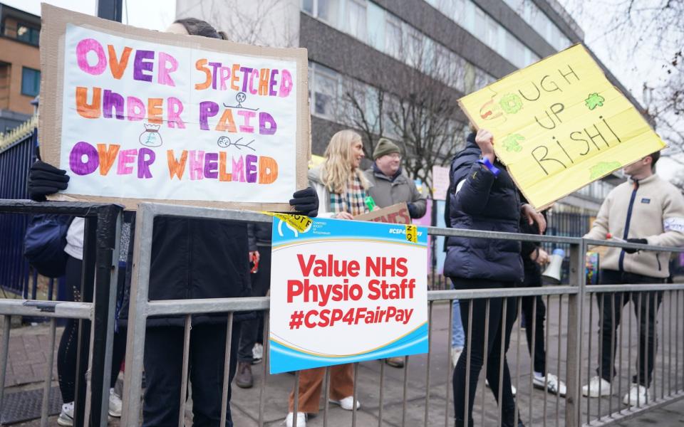 Members of the Chartered Society of Physiotherapy (CSP) on the picket line outside King's College Hospital, London, today - James Manning/PA Wire