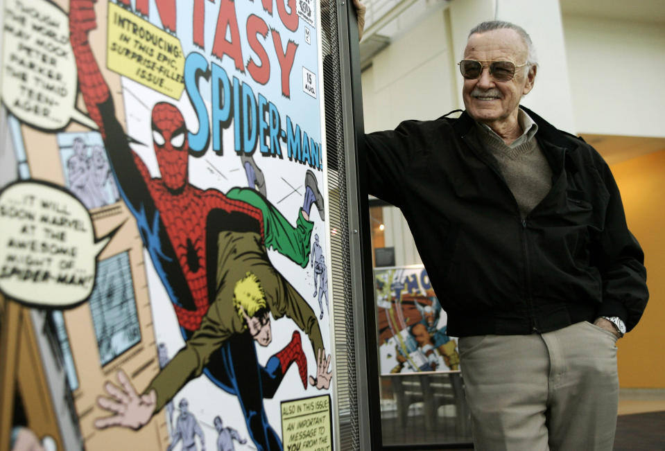 FILE - In this March 21, 2006 file photo, comic book creator Stan Lee stands beside some of his drawings in the Marvel Super Heroes Science Exhibition at the California Science Center in Los Angeles. A former business manager of Stan Lee has been arrested on elder abuse charges involving the late comic book icon. Los Angeles police say Keya Morgan was taken into custody in Arizona early Saturday, May 25, 2019, on an outstanding arrest warrant. Morgan was charged earlier this month with felony allegations of theft, embezzlement, forgery or fraud against an elder adult, and false imprisonment of an elder adult. (AP Photo/Damian Dovarganes, File)