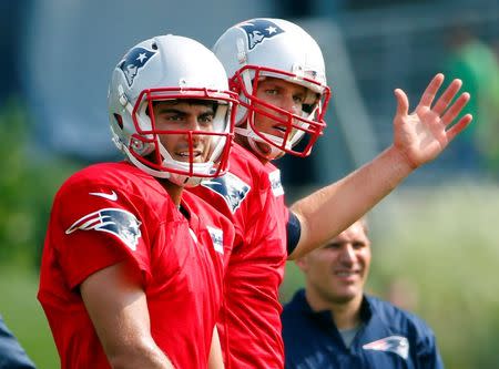 Jul 30, 2015; Foxborough, MA, USA; New England Patriots quarterback Jimmy Garoppolo (10) (left) and quarterback Tom Brady (12) participate in training camp at Gillette Stadium. Mandatory Credit: Winslow Townson-USA TODAY Sports