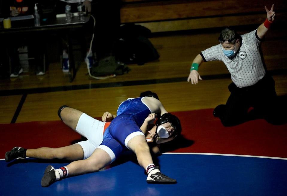 The referee signals two points for Ashland's Kevin Botsis (top) during his 195 lbs. bout against Wayland's Yaseen Nguyen at Ashland Middle School, Jan. 13, 2021. Botsis won by pin and secured the victory for Ashland.