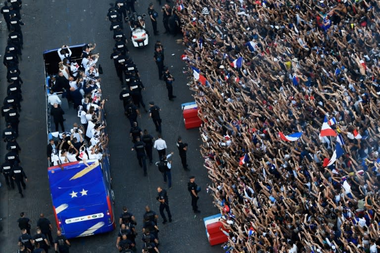 Hundreds of thousands of fans lined the Champs-Elysee parade route, which was secured with a heavy police presence