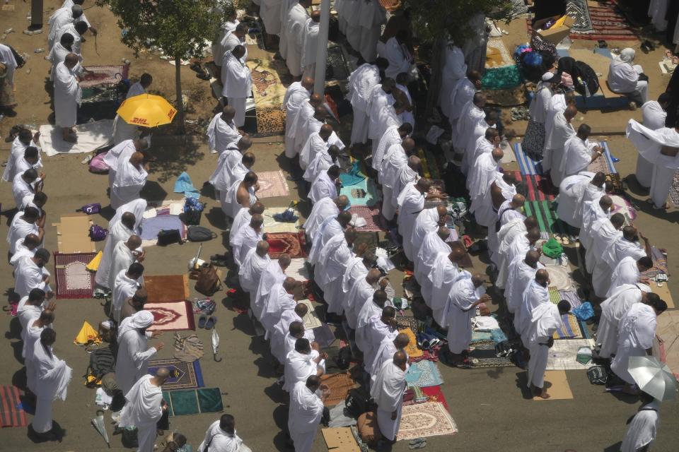Muslim pilgrims perform Friday Prayers outside the Namira Mosque in Arafat, on the second day of the annual hajj pilgrimage, near the holy city of Mecca, Saudi Arabia, Friday, July 8, 2022. (AP Photo/Amr Nabil)