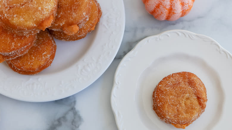 pumpkin filled donuts on plates