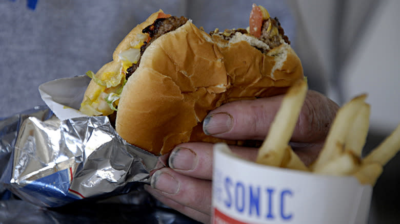 hand holding sonic burger