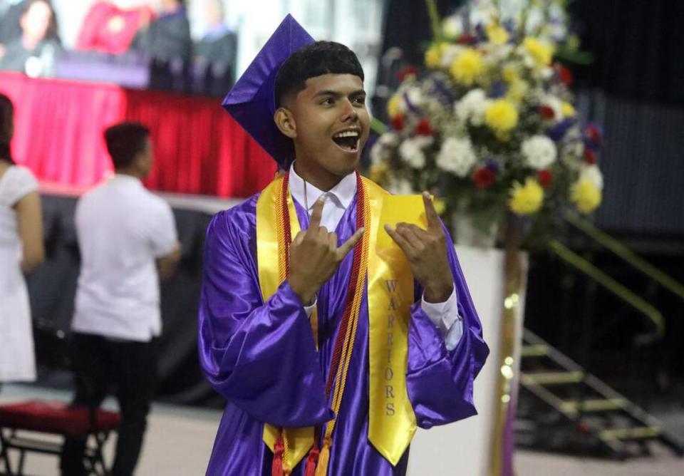 A graduate reacts after spotting familiar faces in the crowd during the Fresno High graduation ceremony held at the Save Mart Center on June 5, 2023.