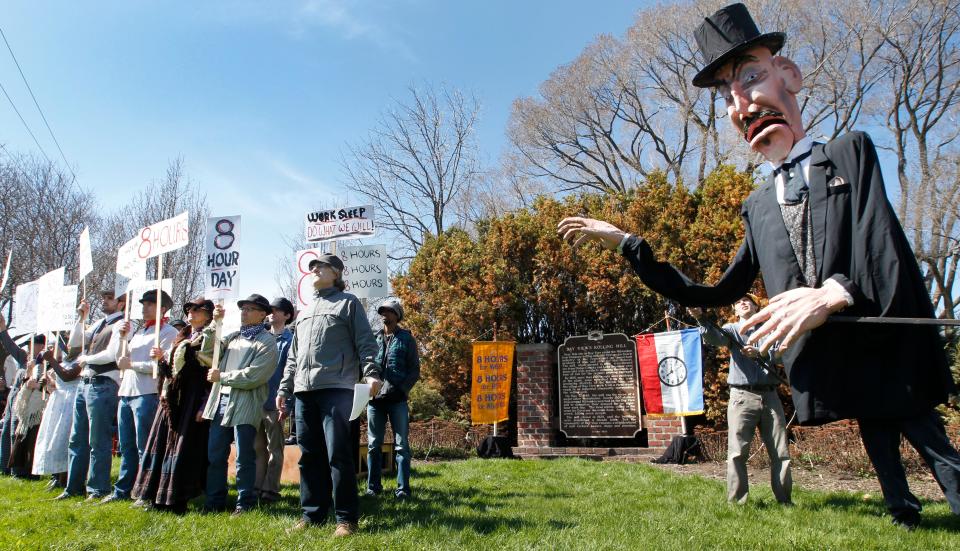 The effigy of Wisconsin Gov. Jeremiah Rusk looms over people portraying marching workers during the 128th Anniversary Commemoration of the Bay View Tragedy Sunday, May, 4 2014 at S. Superior St. and E. Russell Ave. in Milwaukee, Wis. The event, sponsored by the Wisconsin Labor History Society, commemorates the deadliest day in the state's labor movement where seven workers' rights activists were shot and killed by state militia members on May 5, 1886.