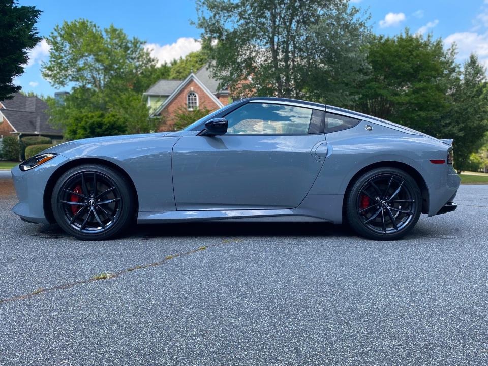 The driver's side of a gray 2024 Nissan Z Performance sports car.