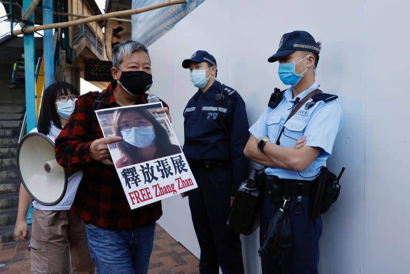 Pro-democracy supporters protest to urge for the release of 12 Hong Kong activists arrested as they reportedly sailed to Taiwan for political asylum and citizen journalist Zhang Zhan outside China's Liaison Office, in Hong Kong