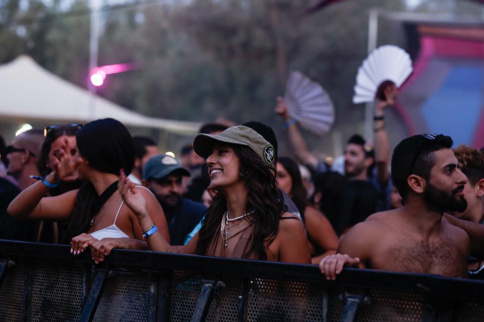 woman smiling in crowd of festival-goers