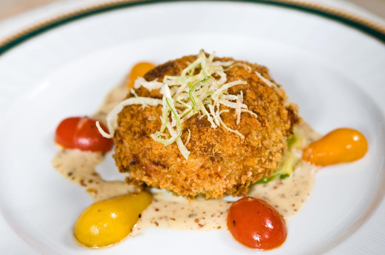 crab cake on ground mustard sauce