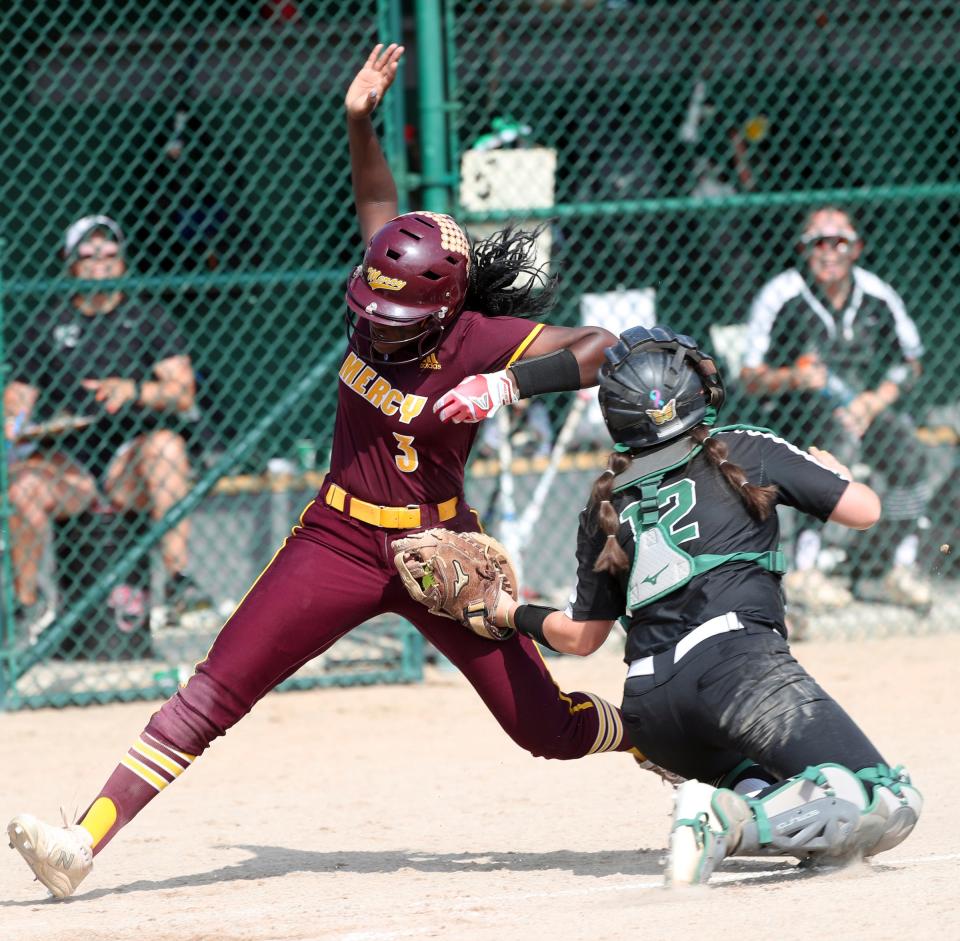 Allen Park's Molly Hool tags out Farmington Hills Mercy's Kendall Spivey during Allen Park's 11-3 win in the Division 1 quarterfinals at Wayne State on Tuesday, June 14, 2022.