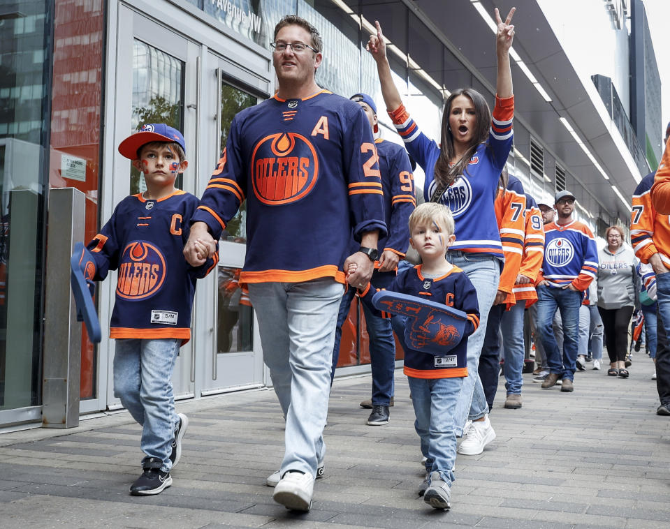 Edmonton Oilers fans arrive for Game 6 of the Western Conference finals of the NHL hockey Stanley Cup playoffs against the Dallas Stars in Edmonton, Alberta, Sunday, June 2, 2024. (Jeff McIntosh/The Canadian Press via AP)