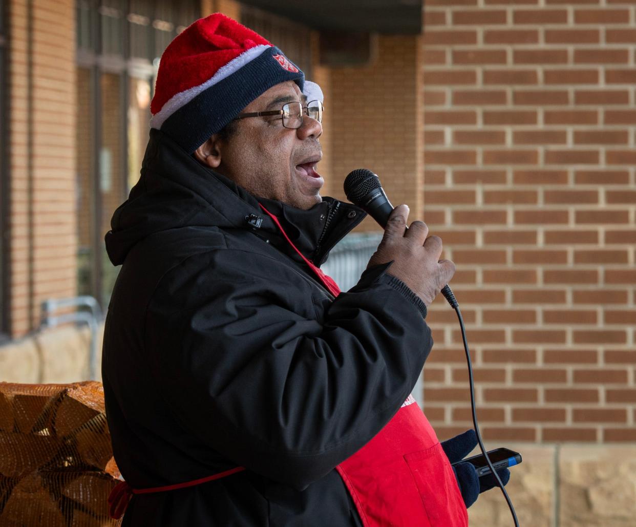 Salvation Army bell ringer Keith Bryant Sr. sings songs outside Roche Bros. Supermarket Friday in Westborough.