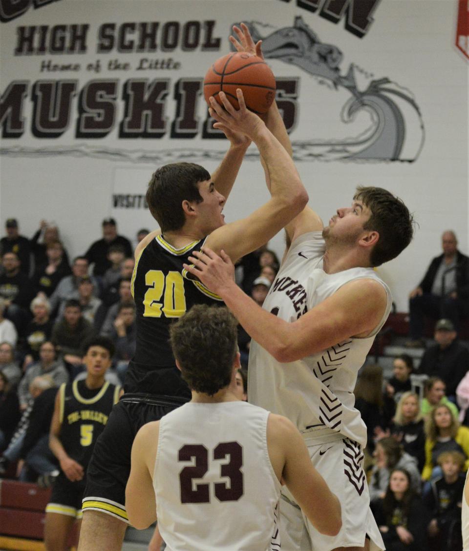 John Glenn's Caleb Larrick contested a shot by Tri-Valley's Aaron Frueh during Tuesday's game. The Scotties won 50-48.