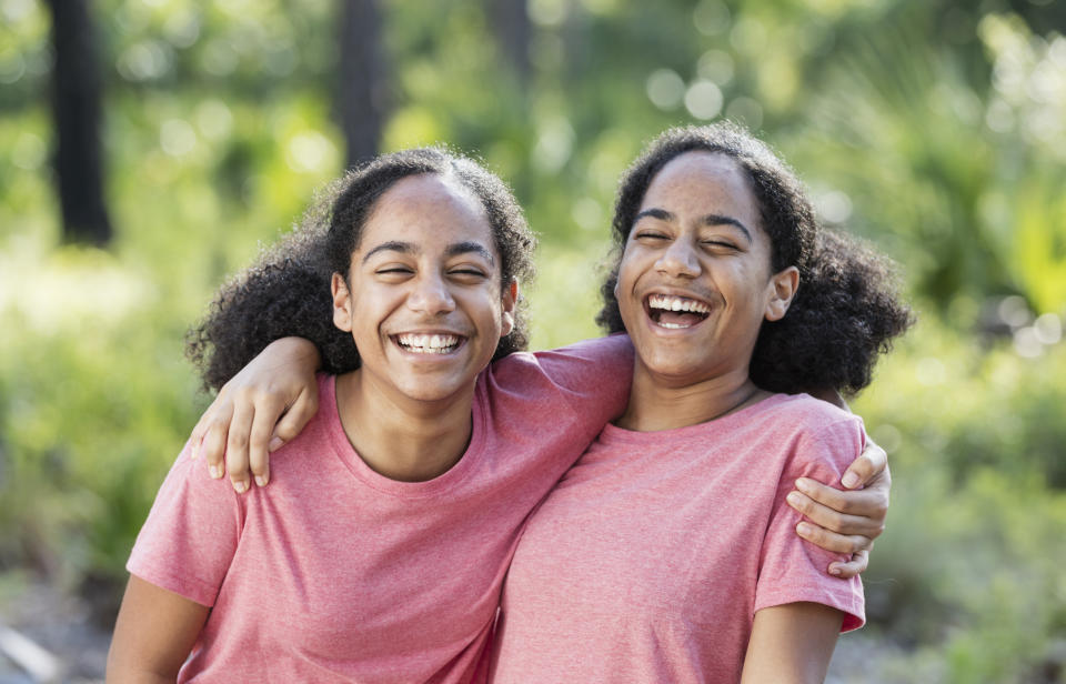 Twin sisters hugging