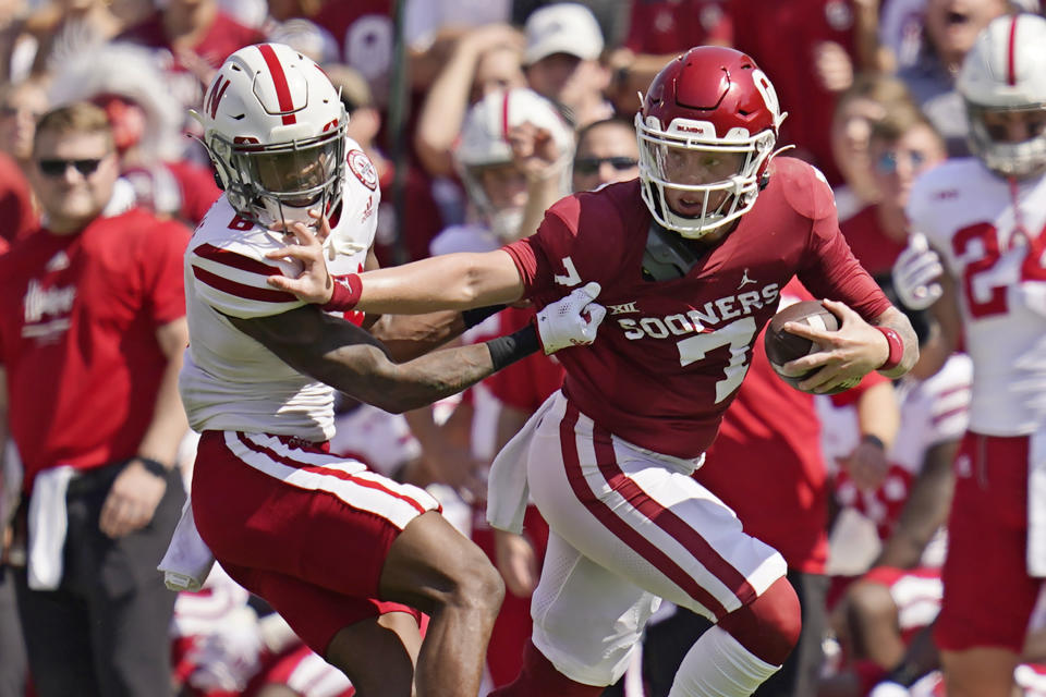 Oklahoma quarterback Spencer Rattler (7) grabs the face mask of Nebraska cornerback Quinton Newsome (6) as he carries in the first half of an NCAA college football game, Saturday, Sept. 18, 2021, in Norman, Okla. (AP Photo/Sue Ogrocki)