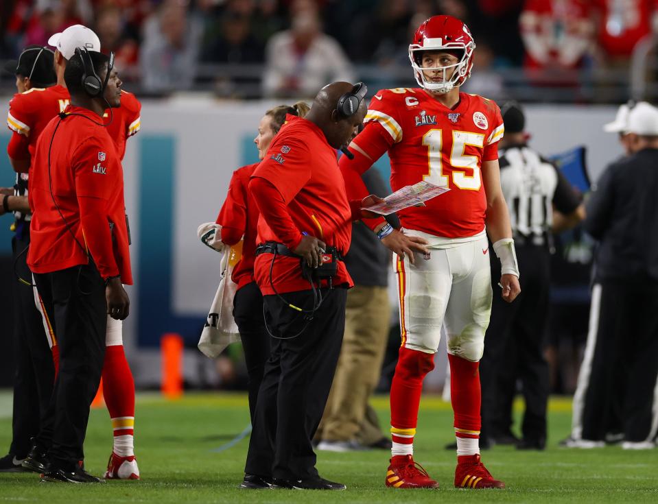 Feb 2, 2020; Miami Gardens, Florida, USA; Kansas City Chiefs quarterback Patrick Mahomes (15) with offensive coordinator Eric Bieniemy during a timeout from the game against the San Francisco 49ers in Super Bowl LIV at Hard Rock Stadium. Mandatory Credit: Matthew Emmons-USA TODAY Sports