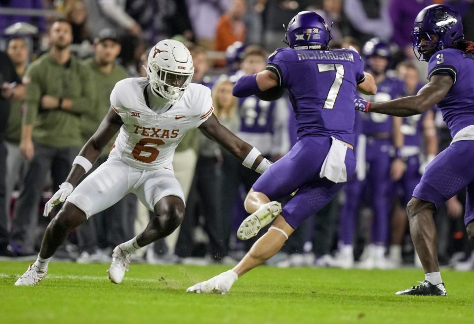 Texas Longhorns defensive back Ryan Watts (6) tries to tackle TCU Horned Frogs wide receiver JP Richardson (7) in the first quarter of an NCAA college football game, Saturday, November. 11, 2023, at Amon G. Carter Stadium in Fort Worth, Texas.