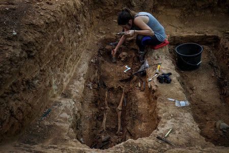 A member of the Association for the Recovery of Historical Memory (ARMH) takes part in the exhumation of Vicente Espliego Andres who was shot in 1939 by forces of dictator Francisco Franco in Guadalajara's cemetery, Spain, May 29, 2017. REUTERS/Juan Medina