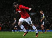 Manchester United's Wayne Rooney celebrates scoring against Bayer Leverkusen during their Champions League soccer match at Old Trafford in Manchester, northern England September 17, 2013. REUTERS/Phil Noble (BRITAIN - Tags: SPORT SOCCER)